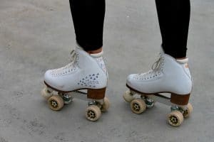  ankles down shot of girl wearing white quad skates decorated with marker