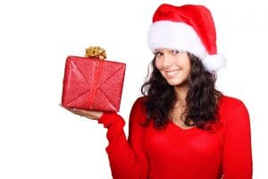 Woman in Santa hat holding Christmas present